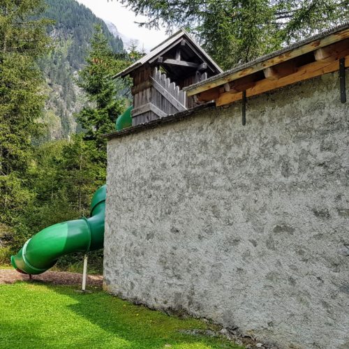Start Wanderweg Seebachtal mit Freizeitzentrum Mallnitz (Erlebnisspielplatz für Kinder). Gebäude mit Rutsche. Ausflugsziele Nationalpark Hohe Tauern Kärnten.