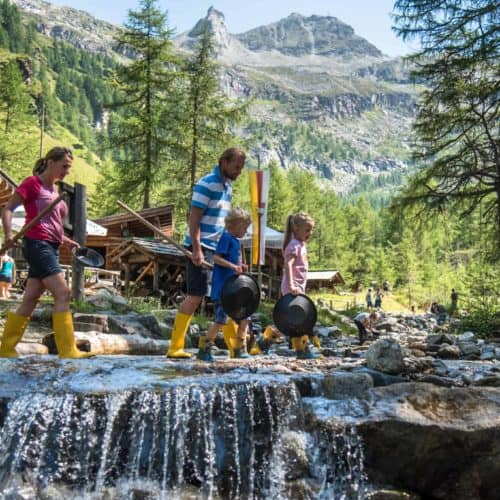 Familie beim Goldgraben im Goldgräberdorf Heiligenblut Nahe Großglockner in Kärnten. Ausflugsziele mit Kindern in Österreich.